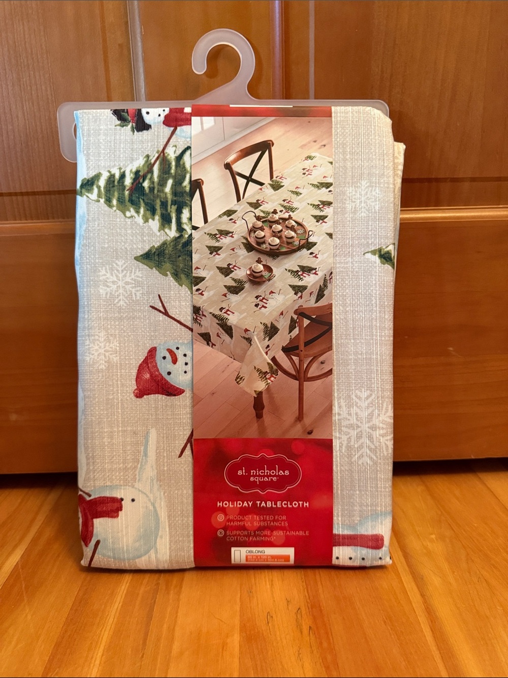 St. Nicholas Square Cream Tablecloth with Green Trees & Red Snowmen